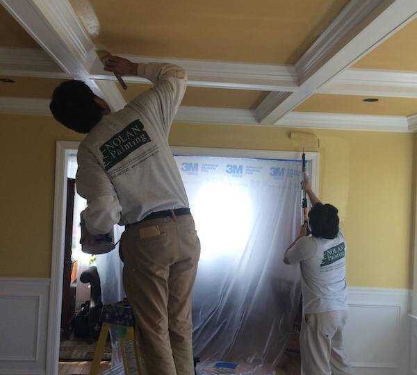 employees painting walls and ceiling